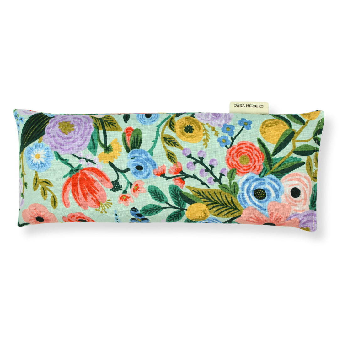 A rectangular eye pillow with a colorful floral pattern.