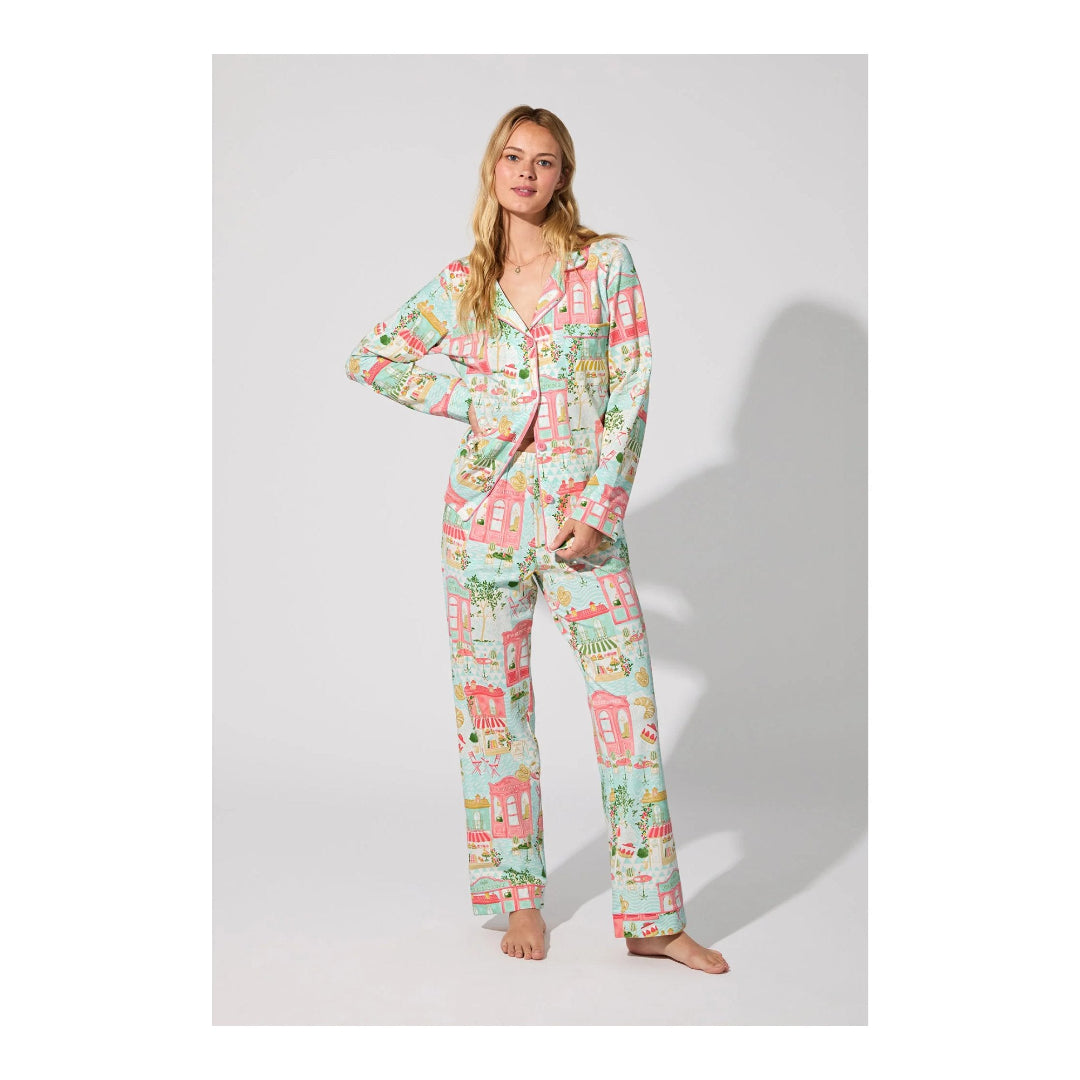 Woman wearing a colorful pajama set on a white background