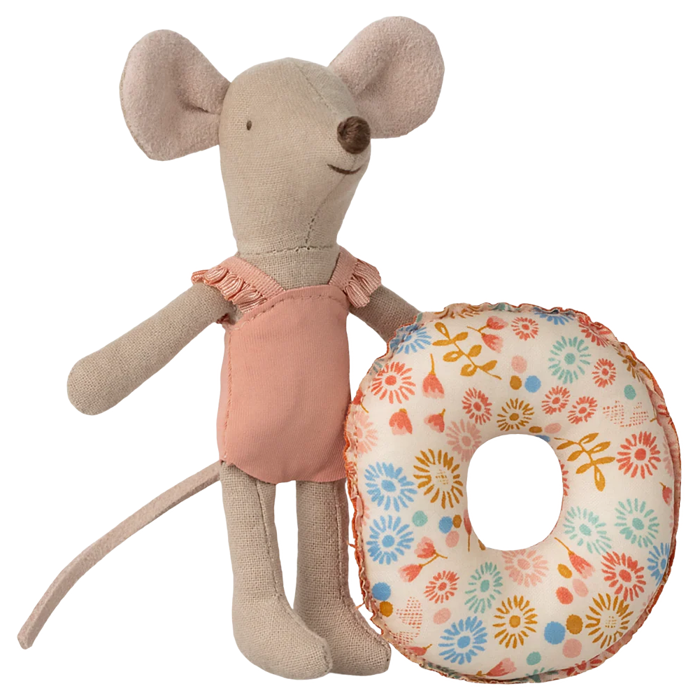 Stuffed mouse toy holding a floral cushion on a white background
