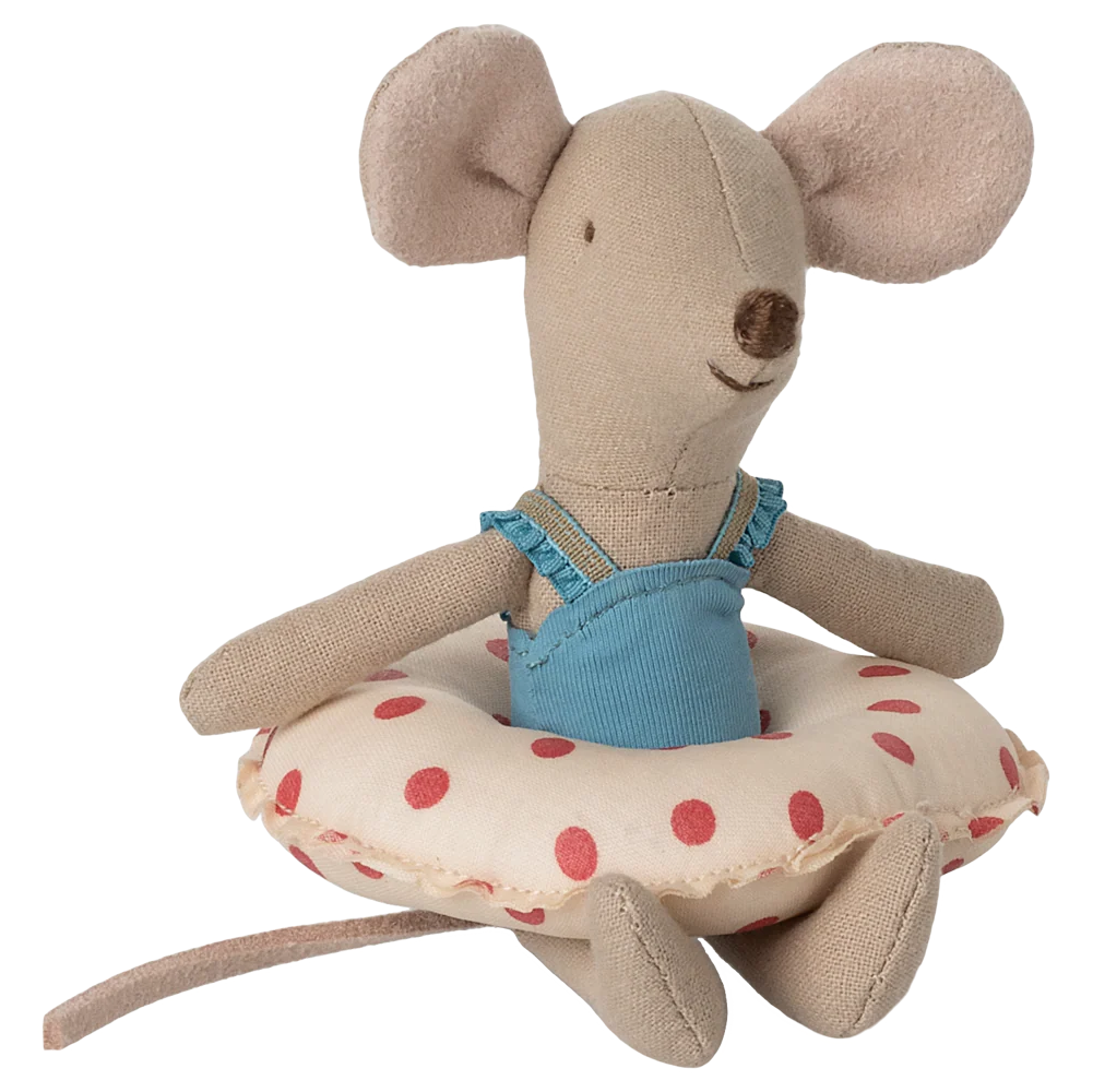 Stuffed mouse toy with a blue dress and polka dot cushion on a white background