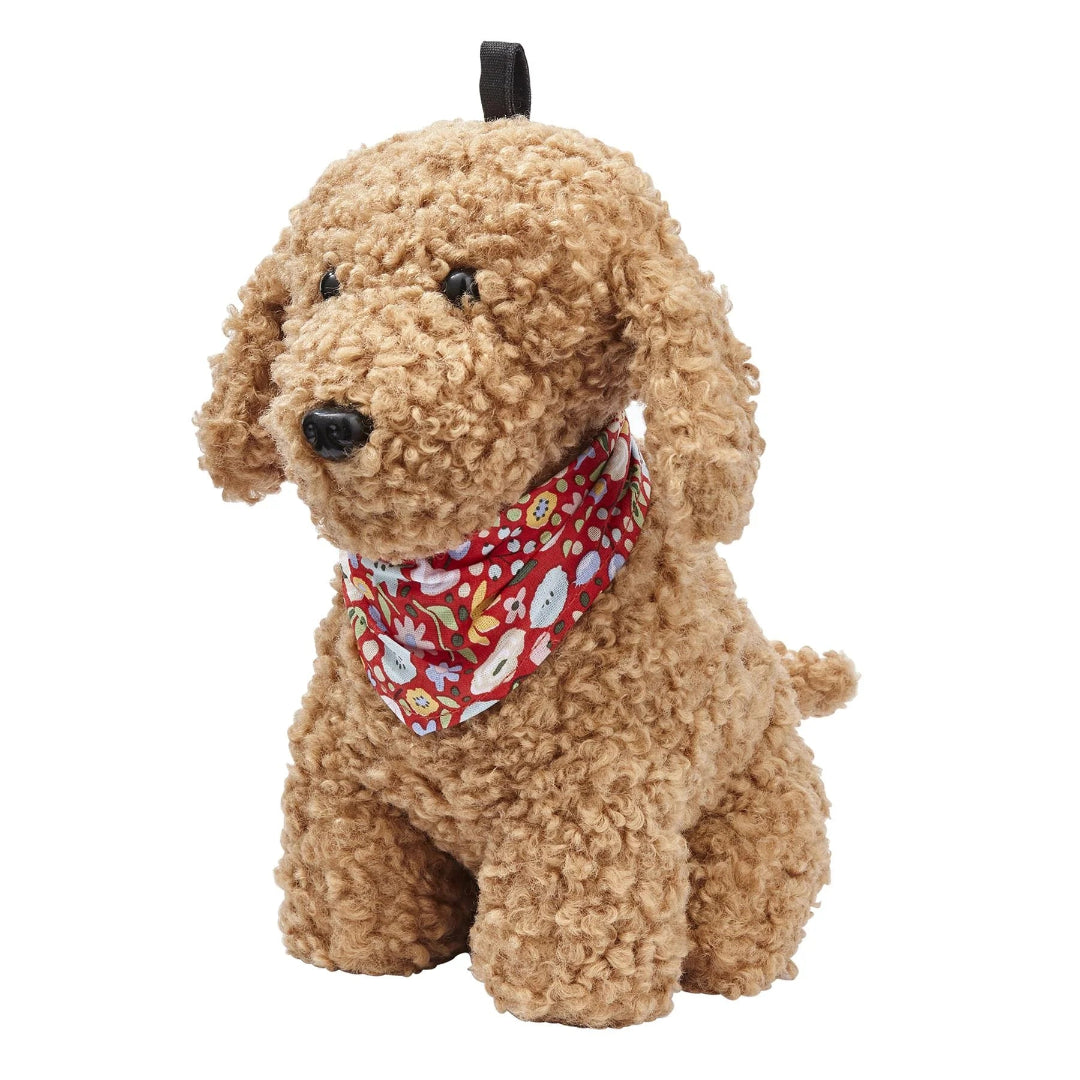 A cockapoo dog-shaped doorstop with golden brown fur, floppy ears, a patterned neckerchief, and a black collar.