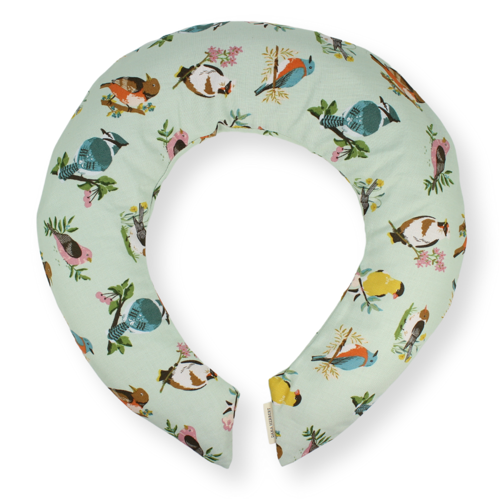 Neck pillow with bird pattern on a light green background