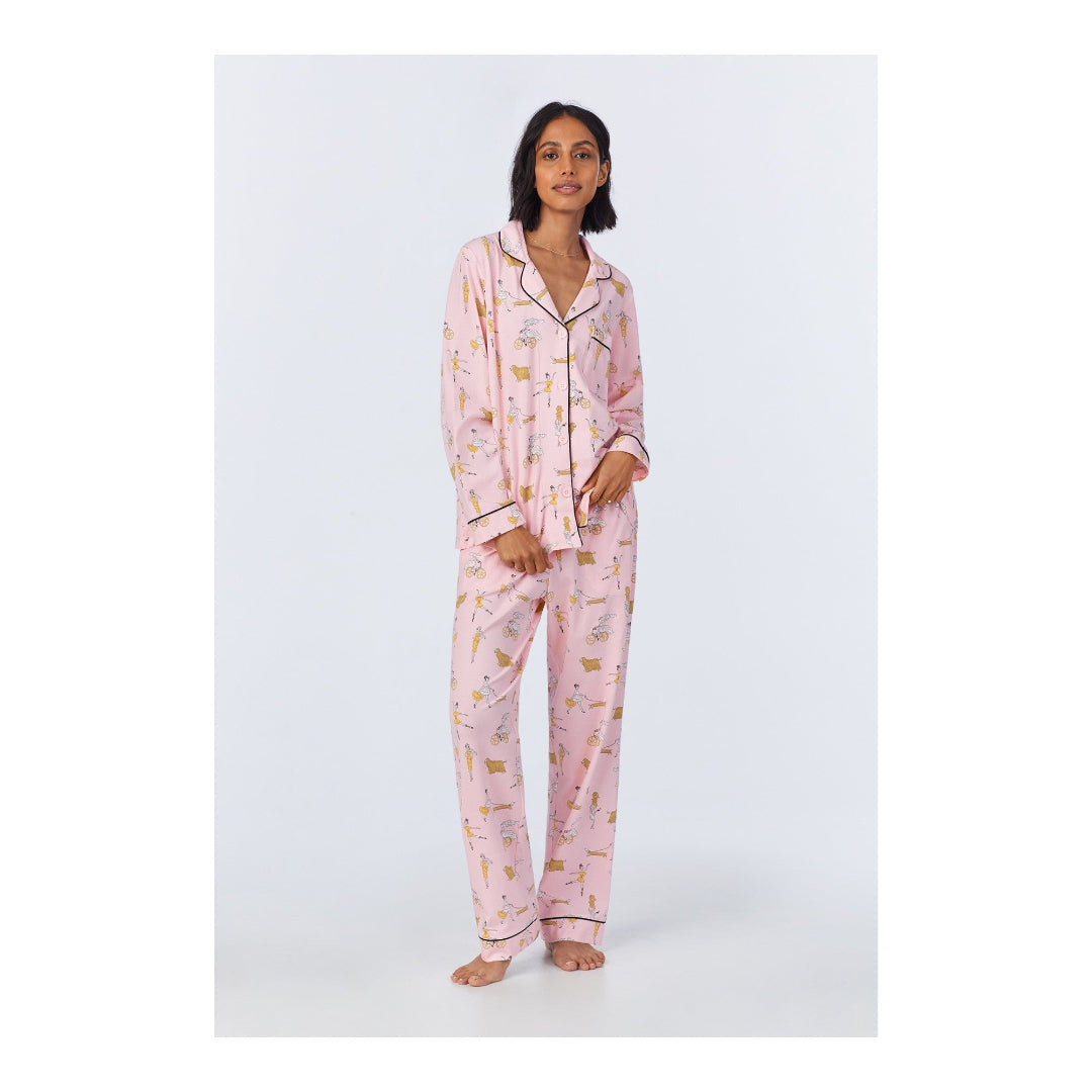 Woman wearing pink pajamas with a subtle pattern on a white background