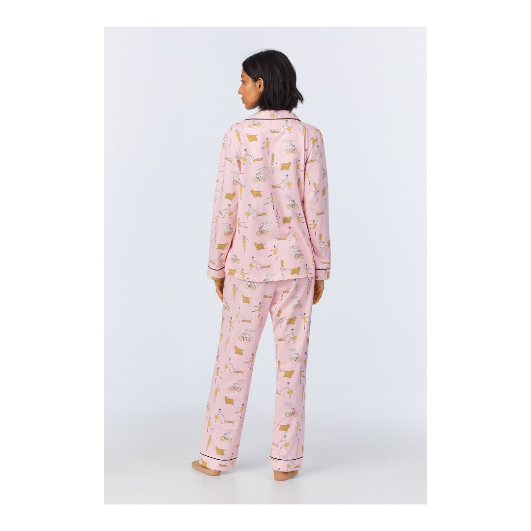 Person wearing pink pajamas with a pattern on a white background