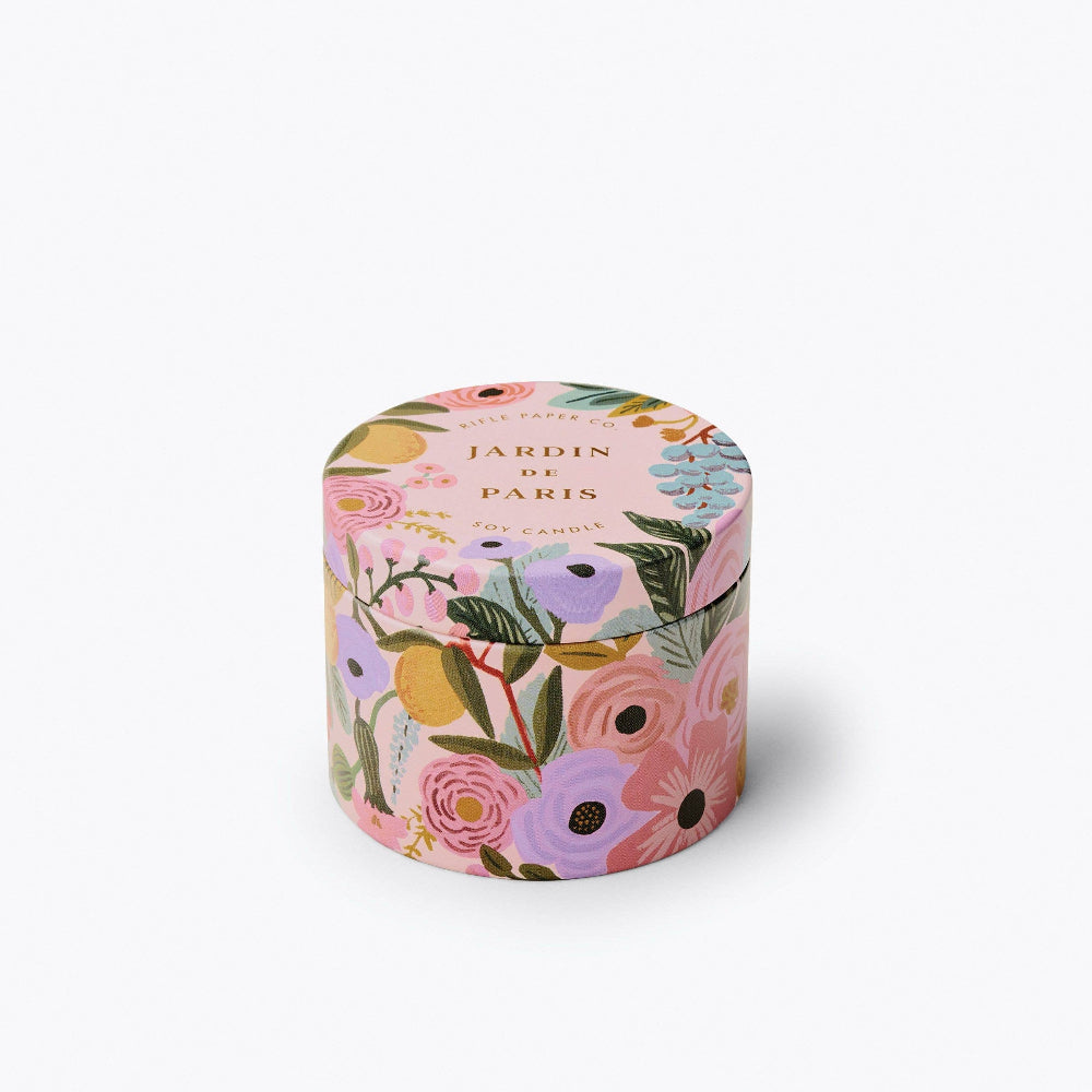 A 3 oz tin candle with a floral design, featuring peonies and other flowers in a variety of colors, covering the entire surface.