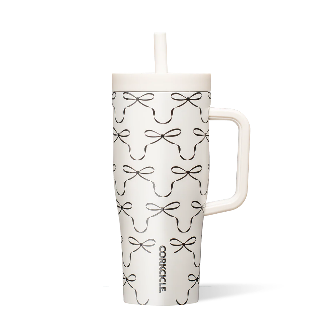 White tumbler with black bow pattern on a white background