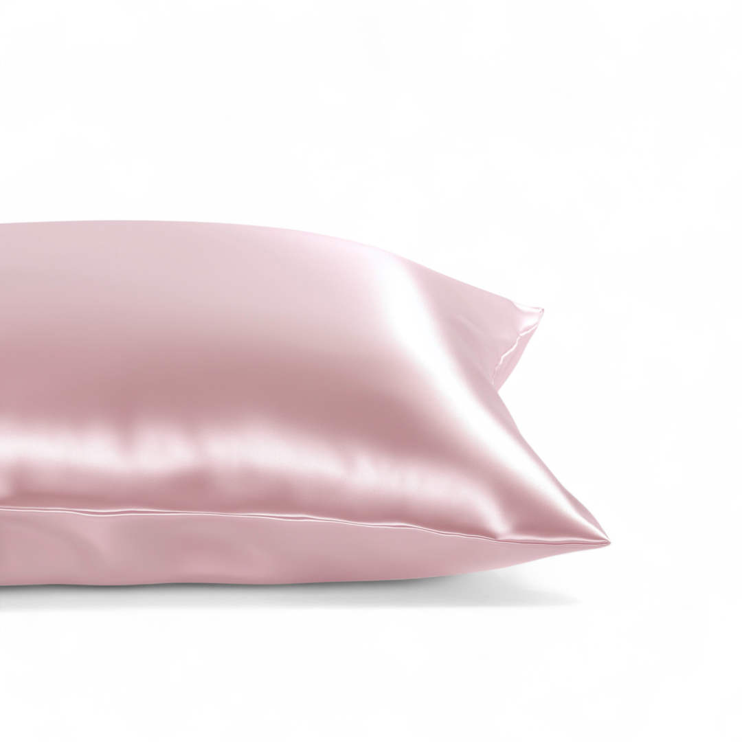 Pink satin pillowcase on a white background