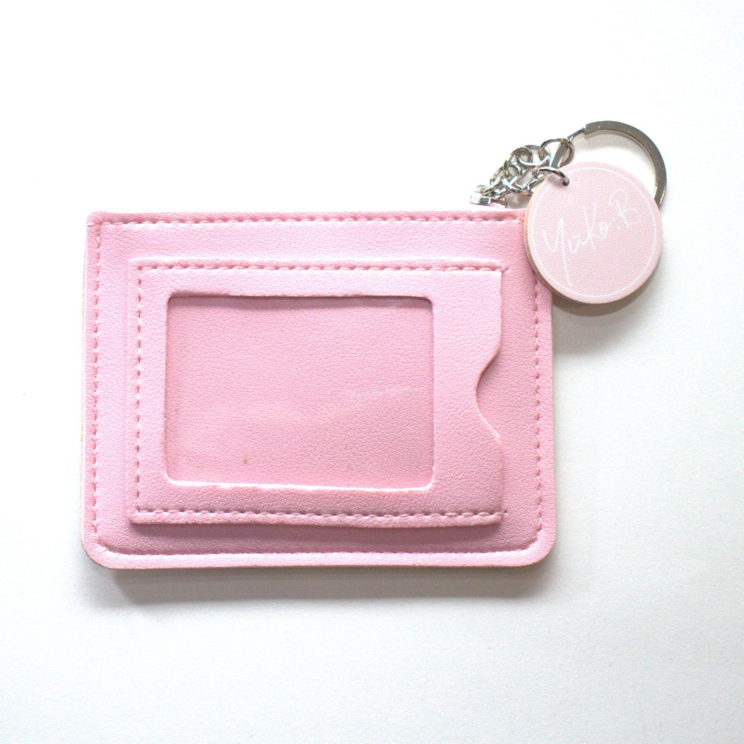 Pink keychain with a card holder on a white background