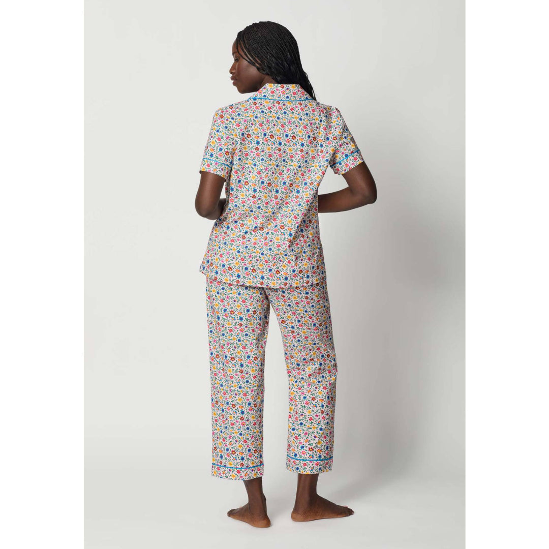 Person wearing a colorful pajama set on a white background