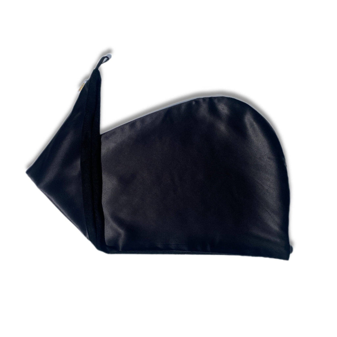 A black reversible silk hair wrap laid out flat, showing one side made from silk and the other side lined with bamboo towel material.