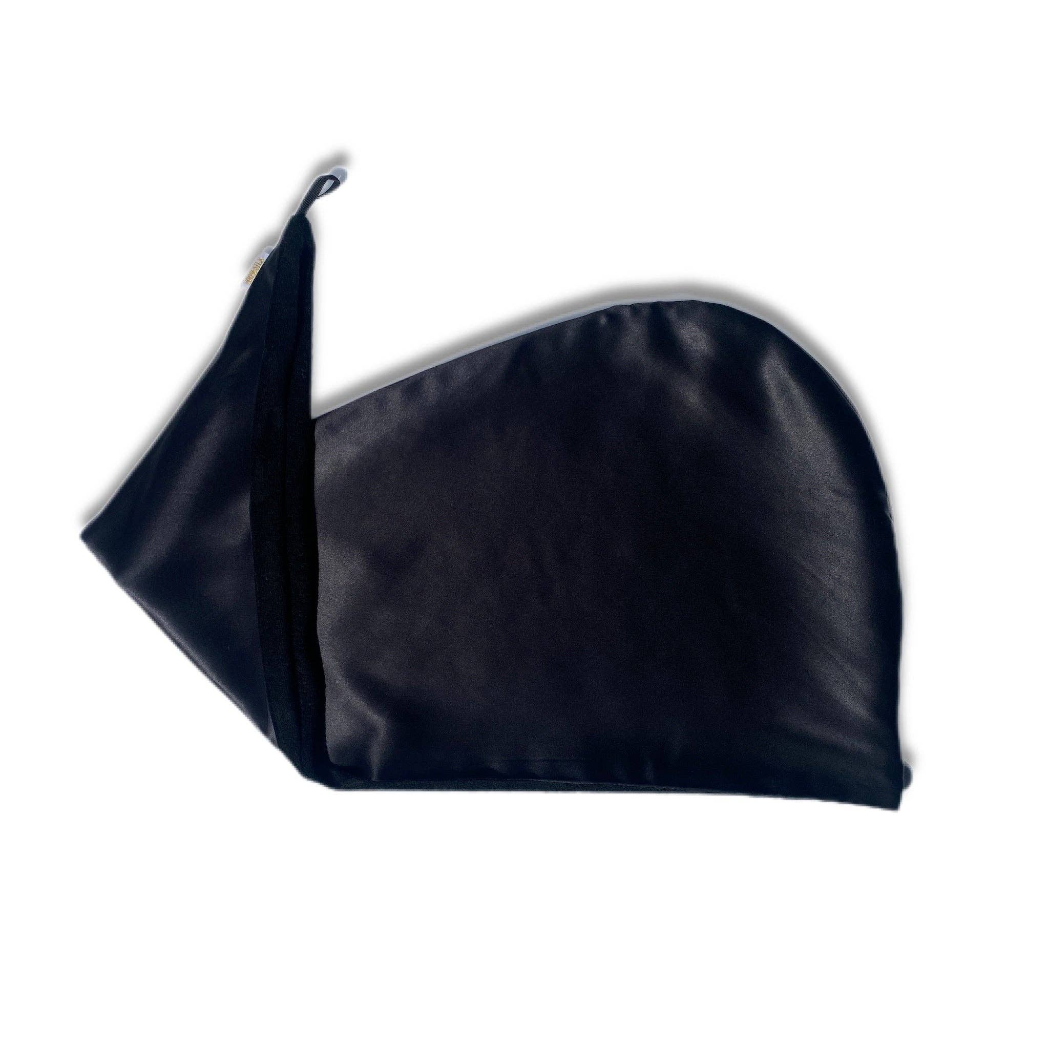 A black reversible silk hair wrap laid out flat, showing one side made from silk and the other side lined with bamboo towel material.
