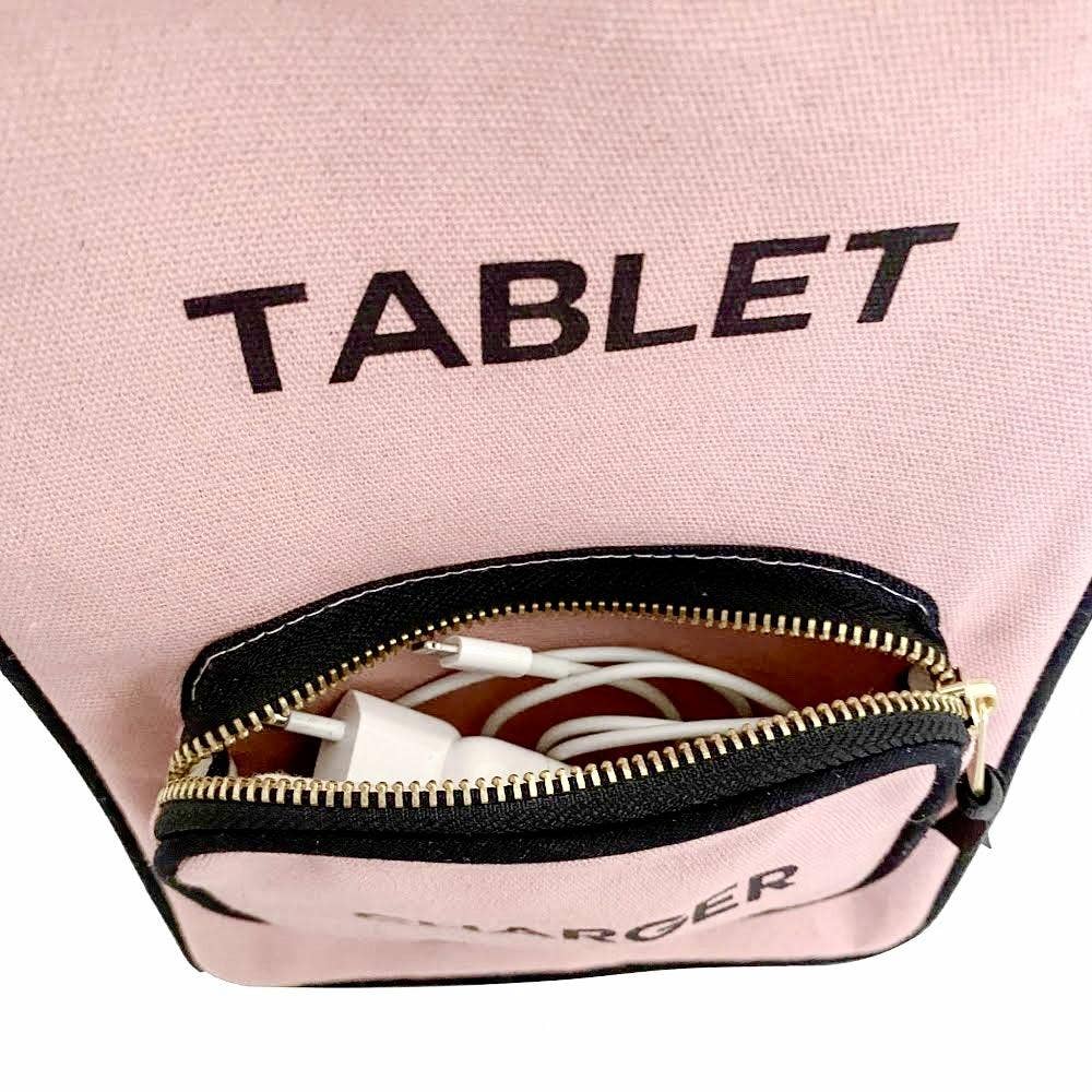 Pink pouch with 'TABLET' and 'CHARGER' labels, containing electronic devices.