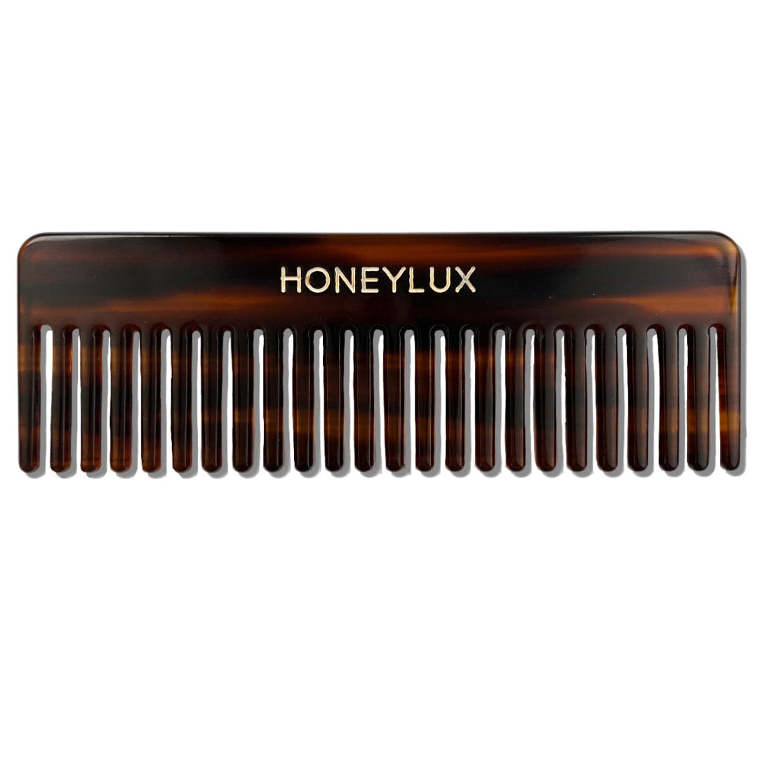 Tortoiseshell comb with 'Honeylux' branding on a white background