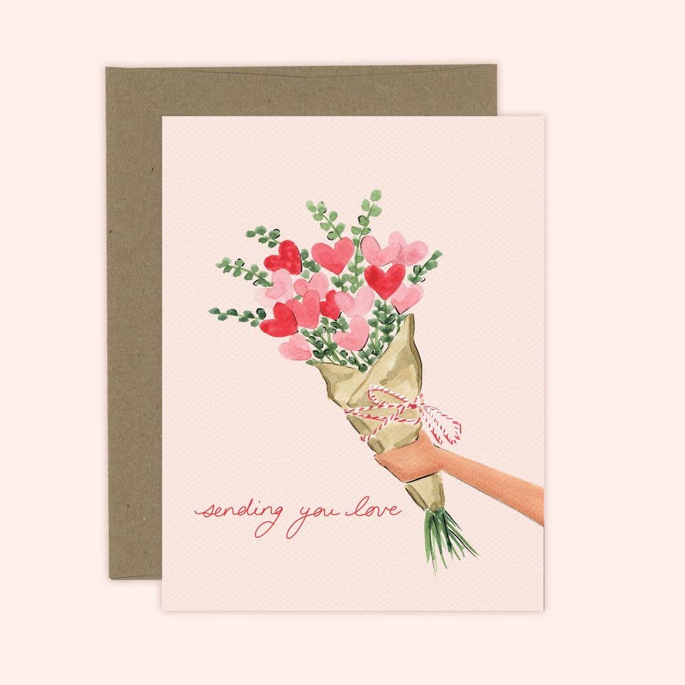 A greeting card featuring a watercolor illustration of a bouquet with hearts and the text 'sending you love', presented with a kraft envelope.