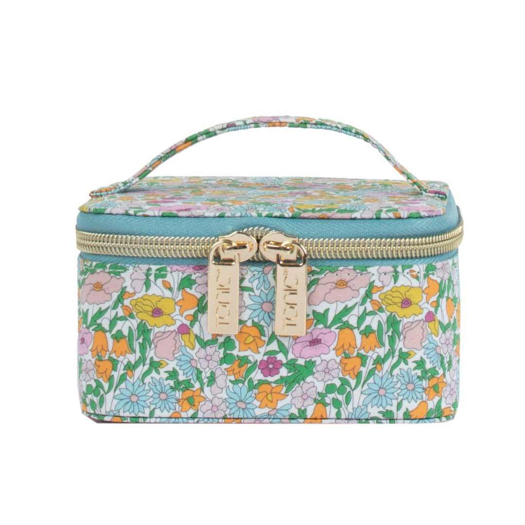 Floral patterned travel case with a gold zipper on a white background