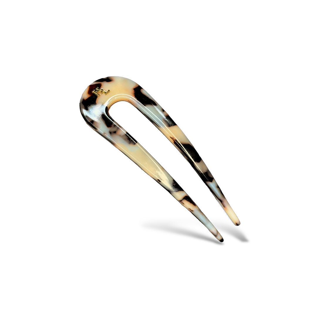 Tortoise hair pick on a white background