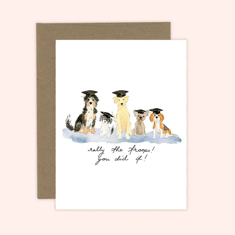 A greeting card with an illustration of five dogs wearing graduation caps and the text 'Grad Pawty! You did it!' accompanied by a brown envelope.
