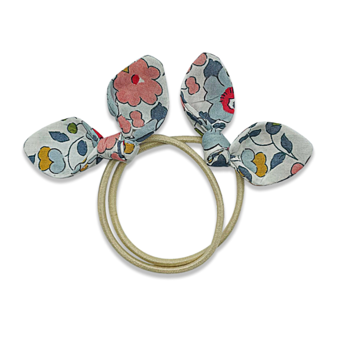 Floral-patterned hair tie with bunny ears on a white background