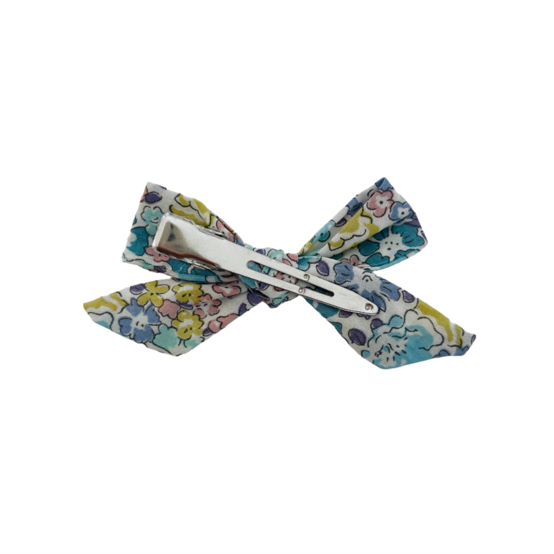 Floral-patterned bow clip on a white background