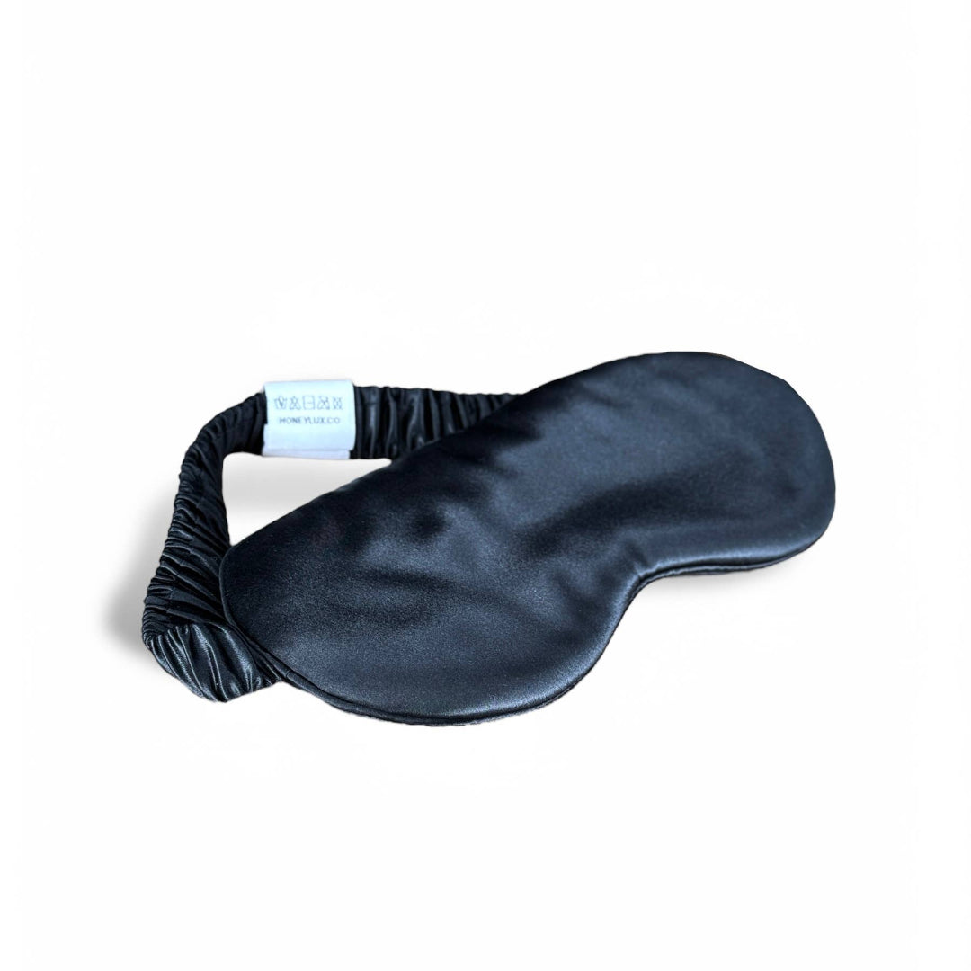 Black silk eye mask on a white background
