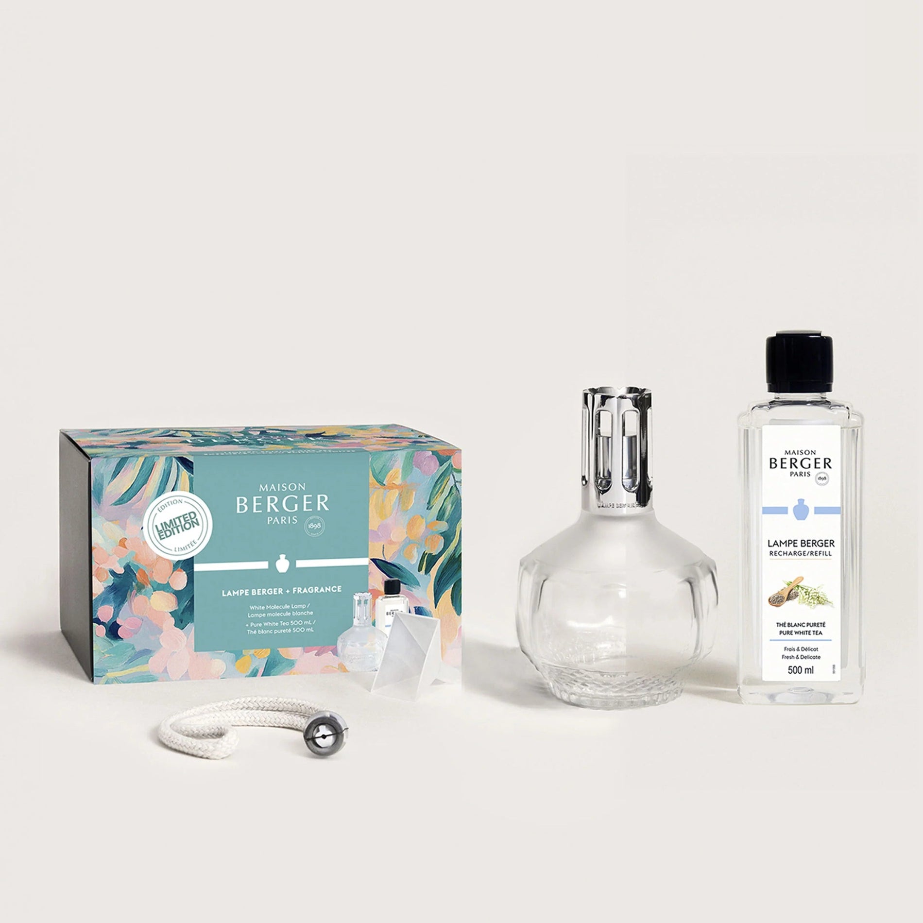 A gift set of a white fragrance lamp with a diffuser top, a printemps collection package, and a bottle of White Tea fragrance, all displayed on a white background.