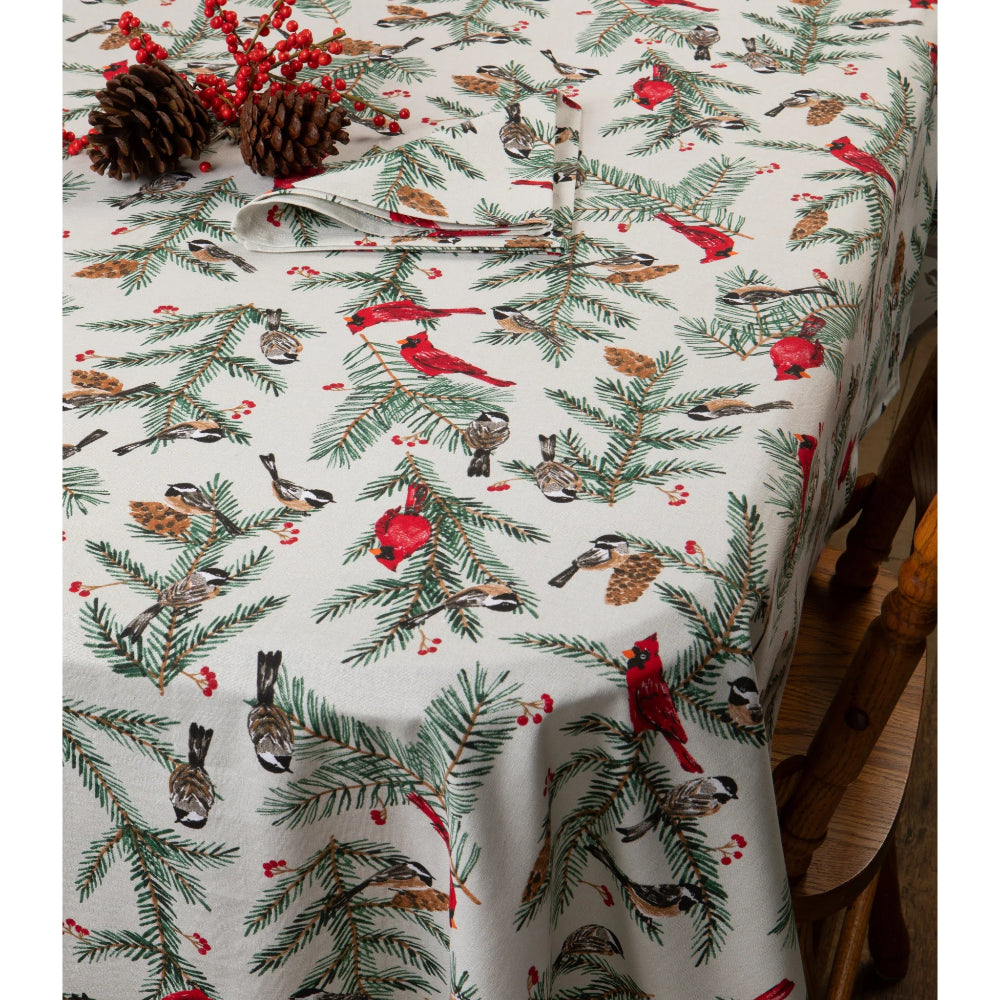 Christmas-themed tablecloth with birds, pine cones, and berries on a white background