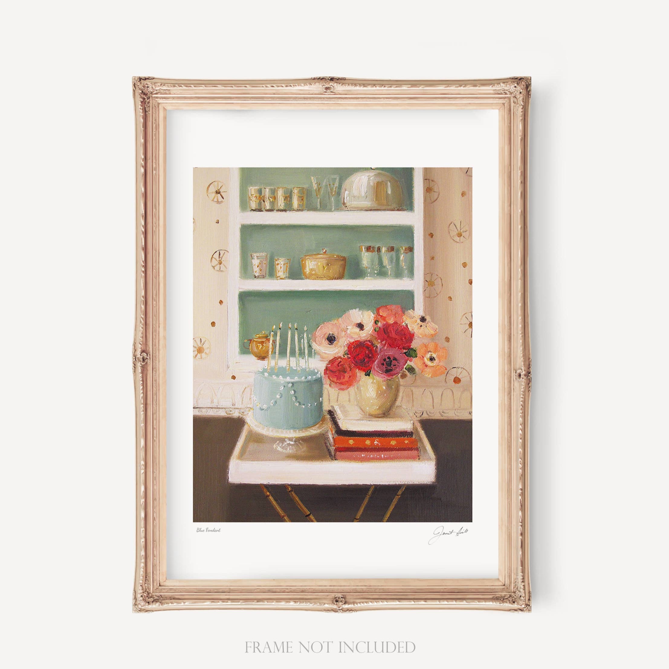 A framed art print featuring a blue fondant decoration, with a shelf of dishes and a vase of flowers in the background, set against a green wall.