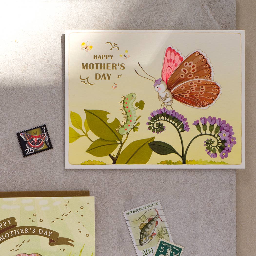 Mother's Day card with butterfly and caterpillar design on a textured surface.