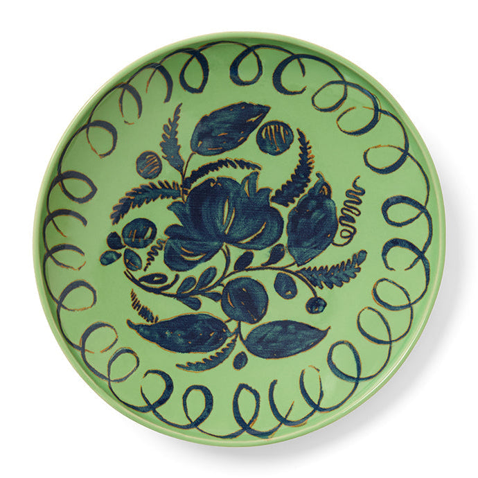 Green ceramic plate with blue floral design on a white background