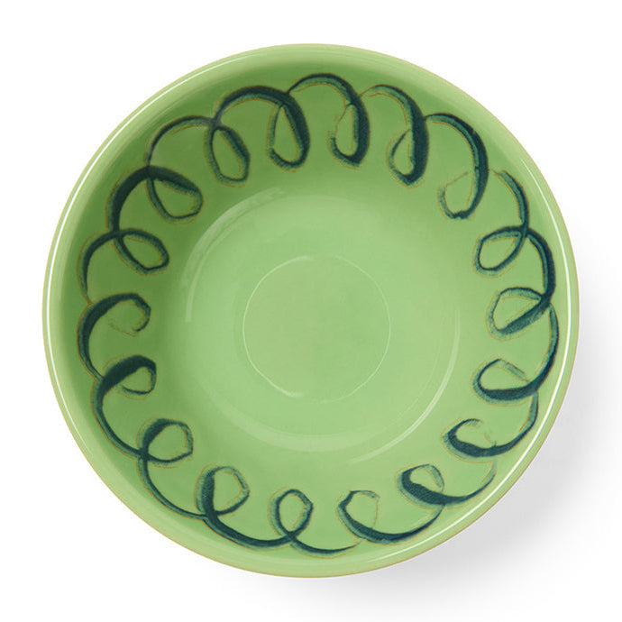 Green ceramic bowl with a decorative pattern on a white background