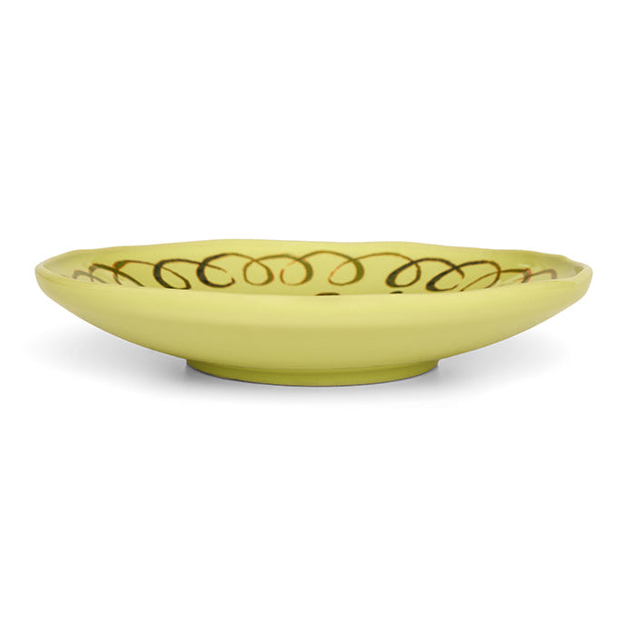 Yellow ceramic bowl with decorative pattern on a white background