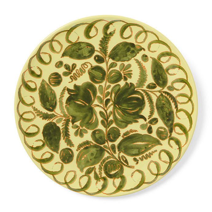 Decorative plate with green floral pattern on a white background