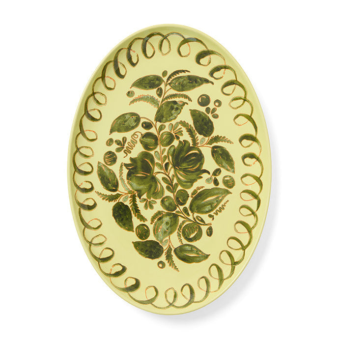 Decorative oval plate with green floral design on a white background