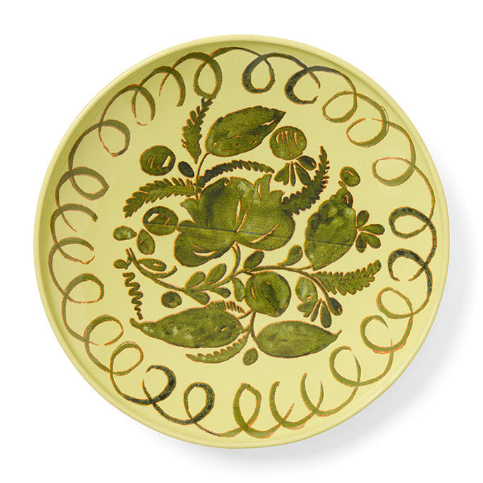 Green decorative plate with green floral design on a white background