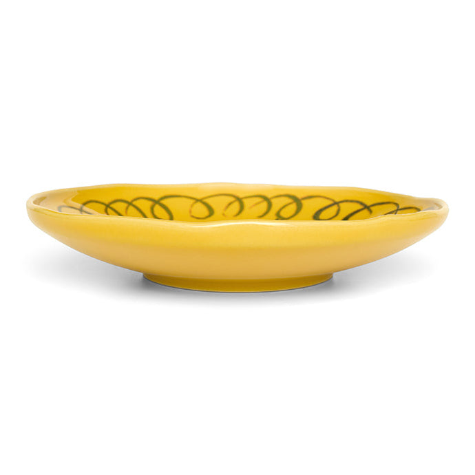 Yellow ceramic bowl with decorative pattern on a white background