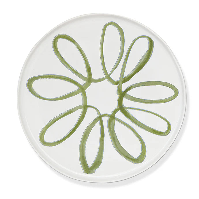 A round white plate featuring a hand-painted green floral or daisy-like pattern in the center, shown against a clean white background.
