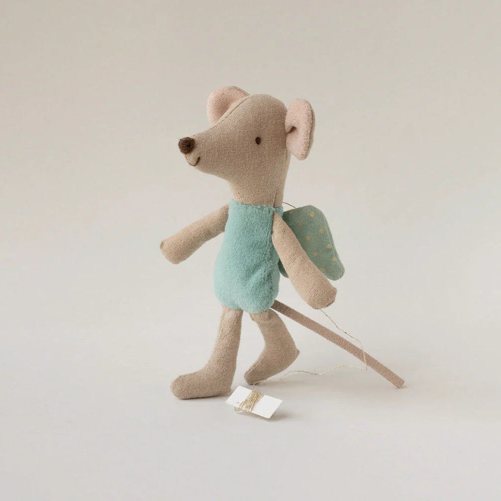 Stuffed toy mouse with a backpack on a plain background