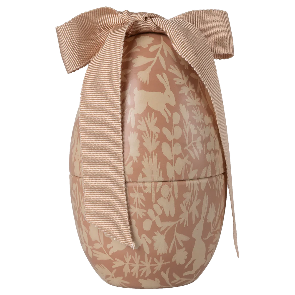 Decorative Easter egg with floral patterns and a bow on a white background