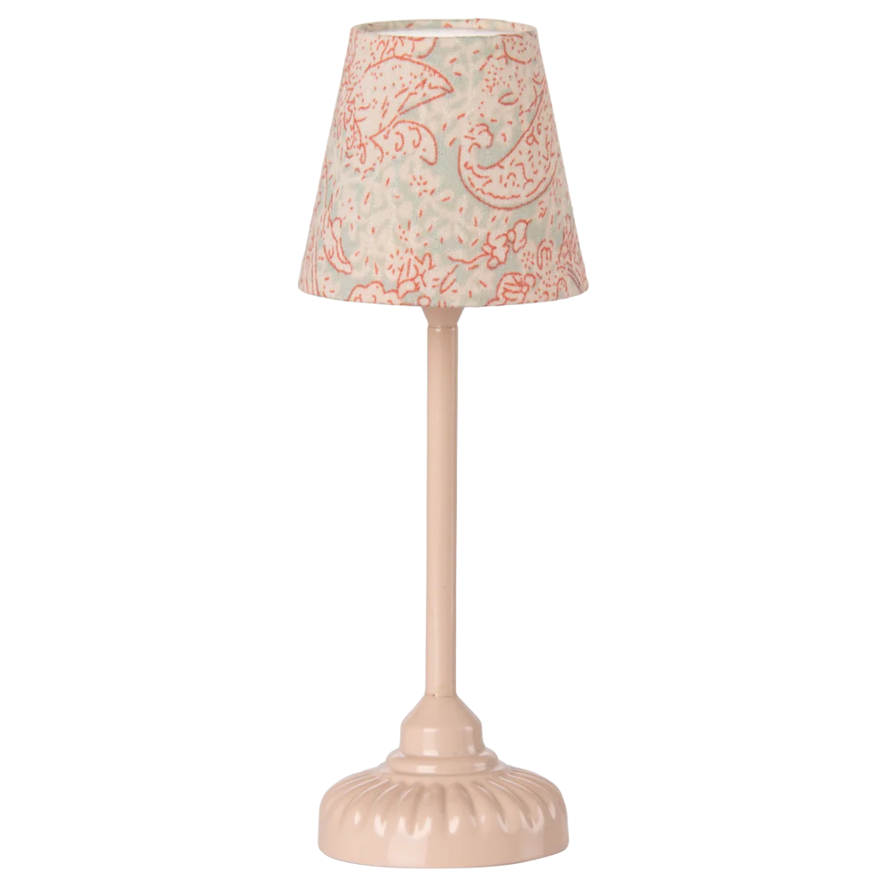 Small table lamp with a decorative pink and white patterned shade on a white background