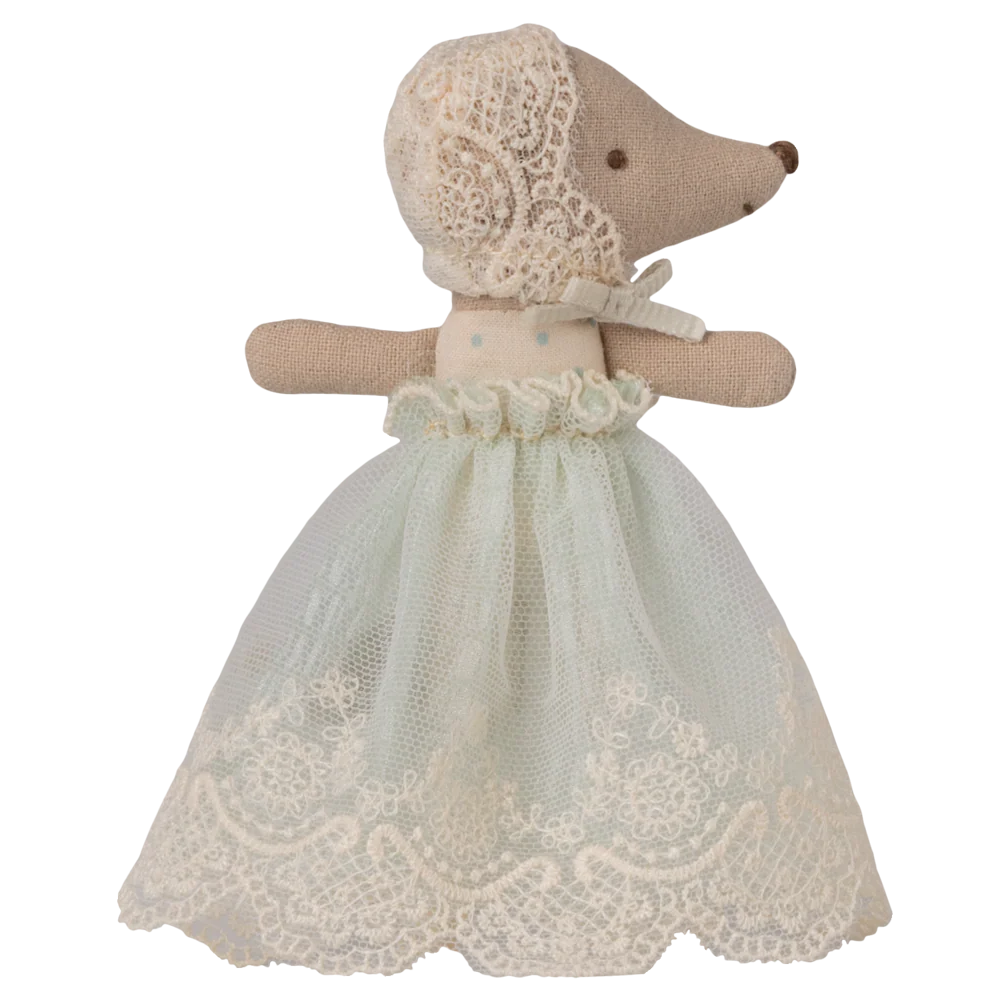 Toy Mouse dressed in a lace dress on a white background