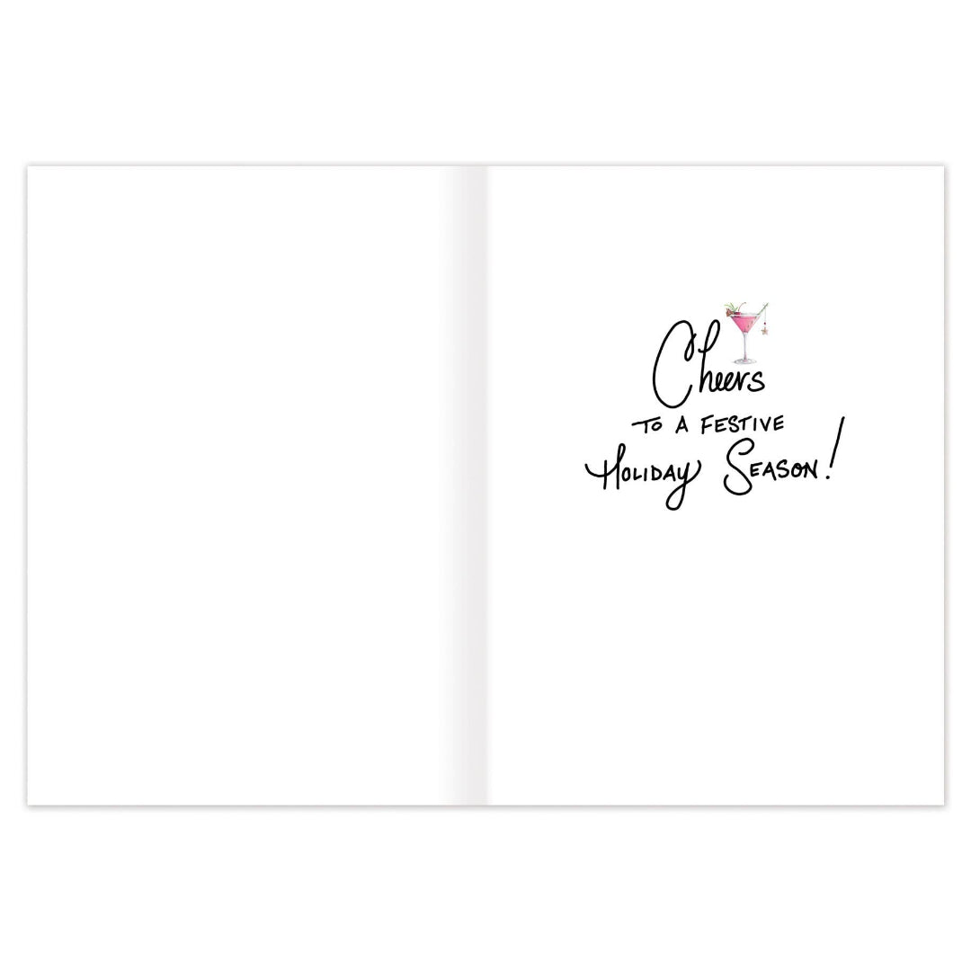 Open greeting card, with black handwritten-style text reading 'Cheers to a festive holiday season!' and a small pink drink icon on the right side.