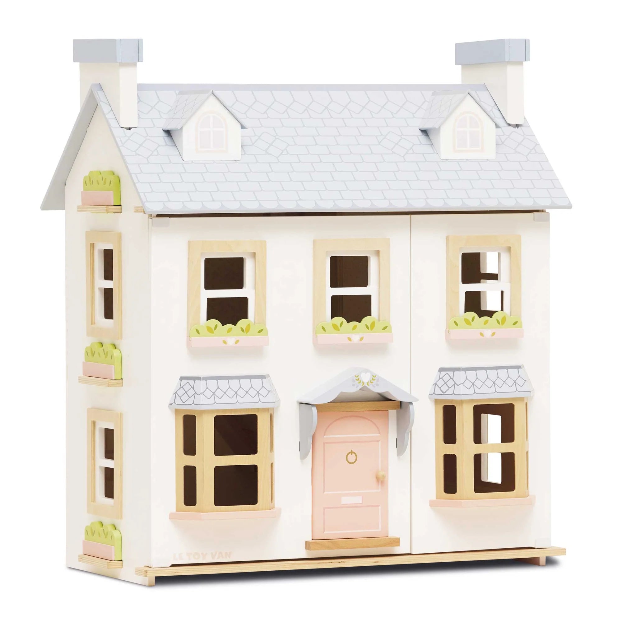 Toy dollhouse with white exterior and pink door on a white background