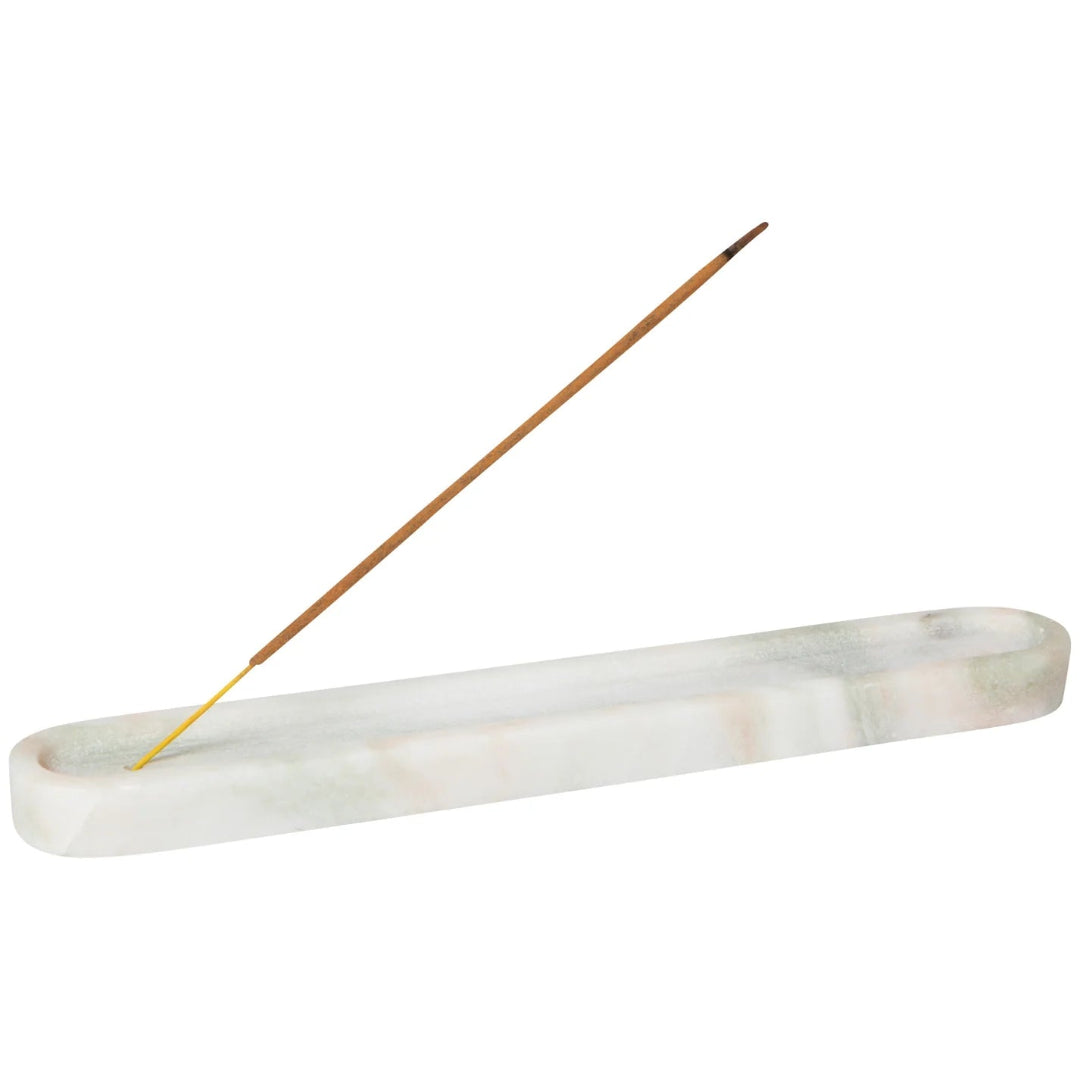 A white marble incense holder with a single brown incense stick 