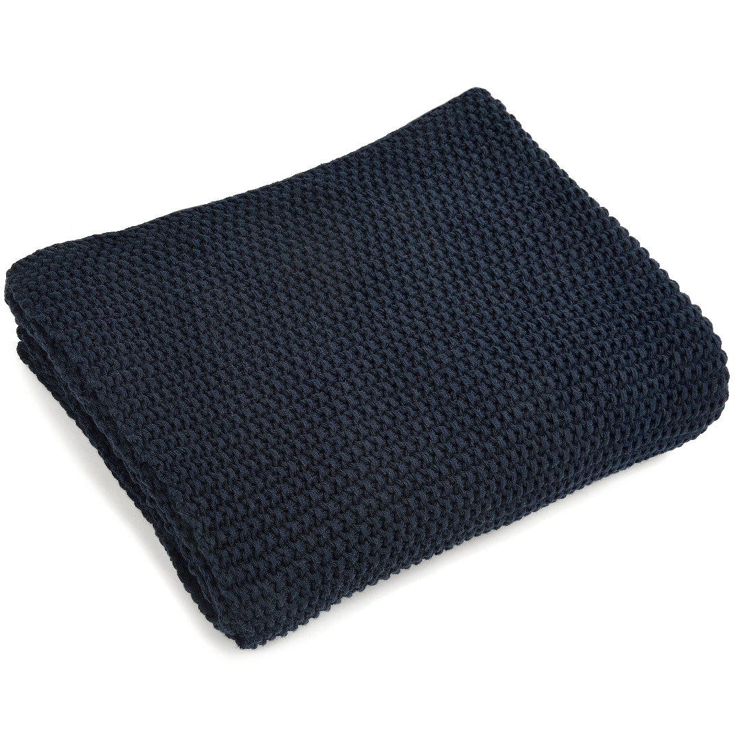 Navy knit throw blanket on a white background