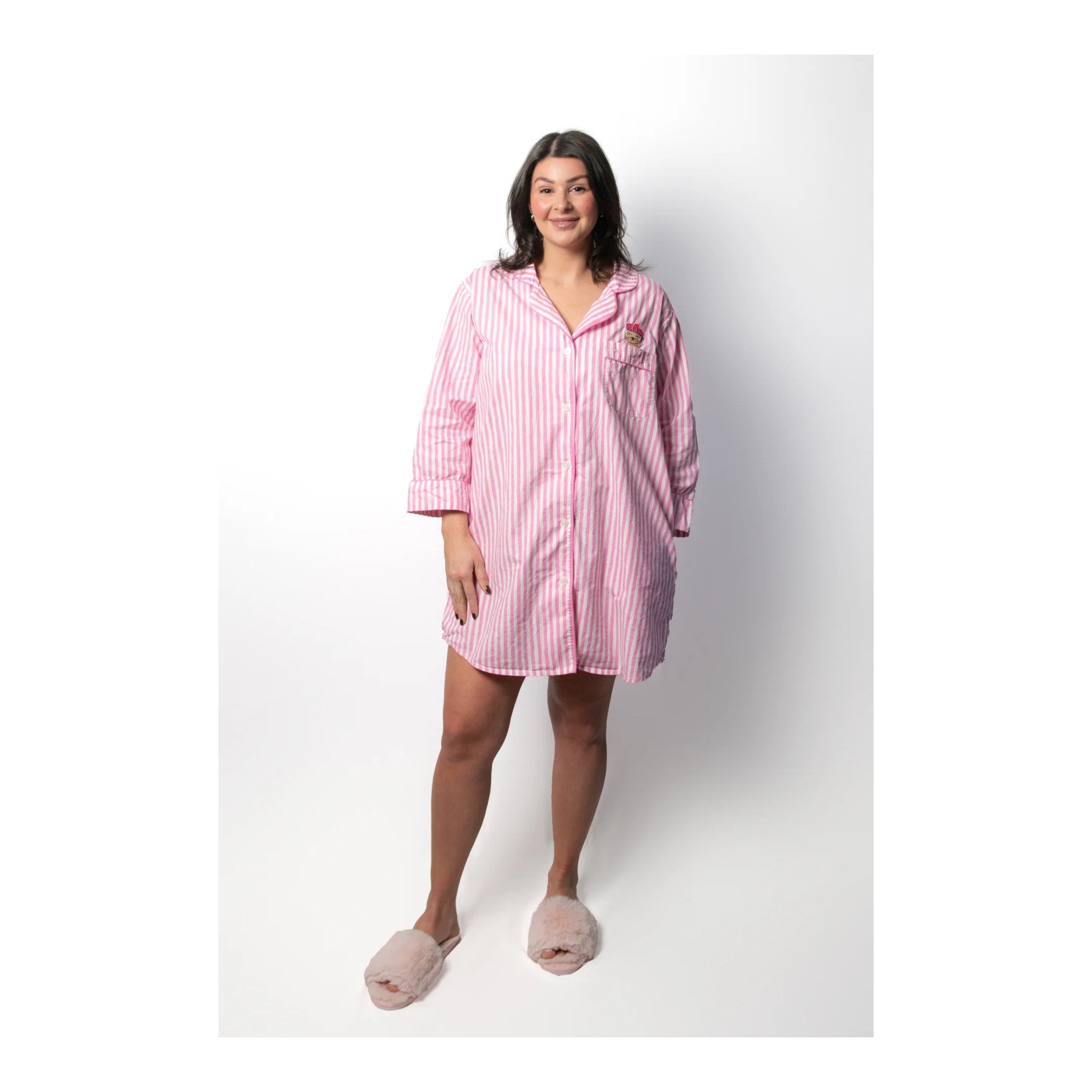 Woman wearing a pink striped nightshirt on a white background
