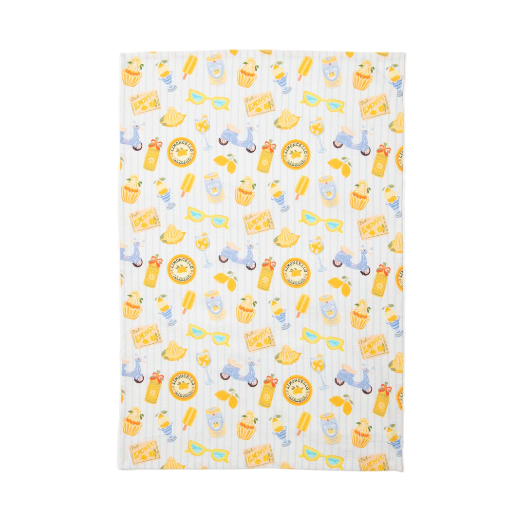 Patterned tea towel with yellow lemon treats and blue stripe designs on a white background