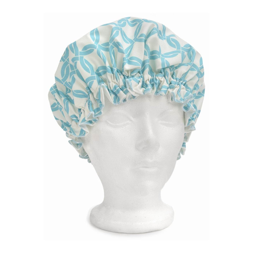 Blue and white patterned shower cap on a mannequin head against a white background