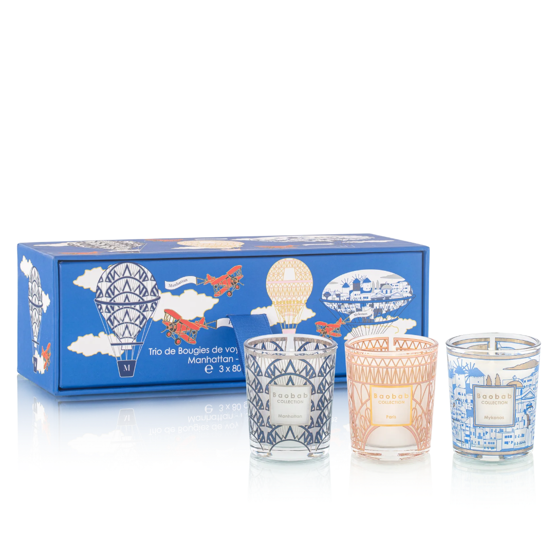 Set of three candles in decorative glass containers with a blue box featuring illustrations on a white background.