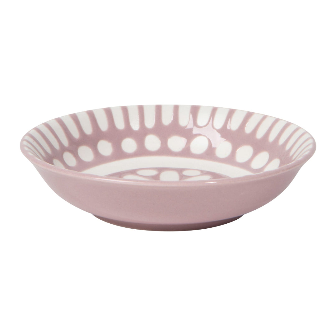 Pink ceramic bowl with white pattern on a white background