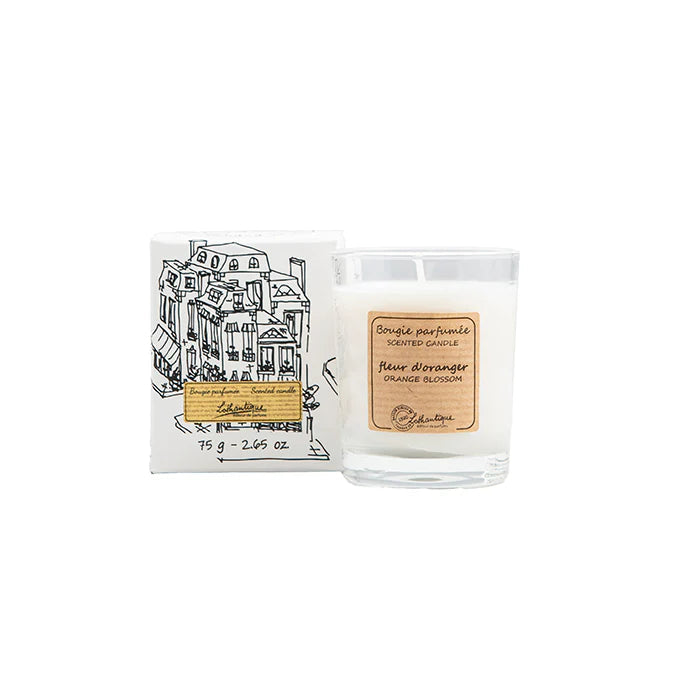 Candle with packaging featuring a building illustration on a white background